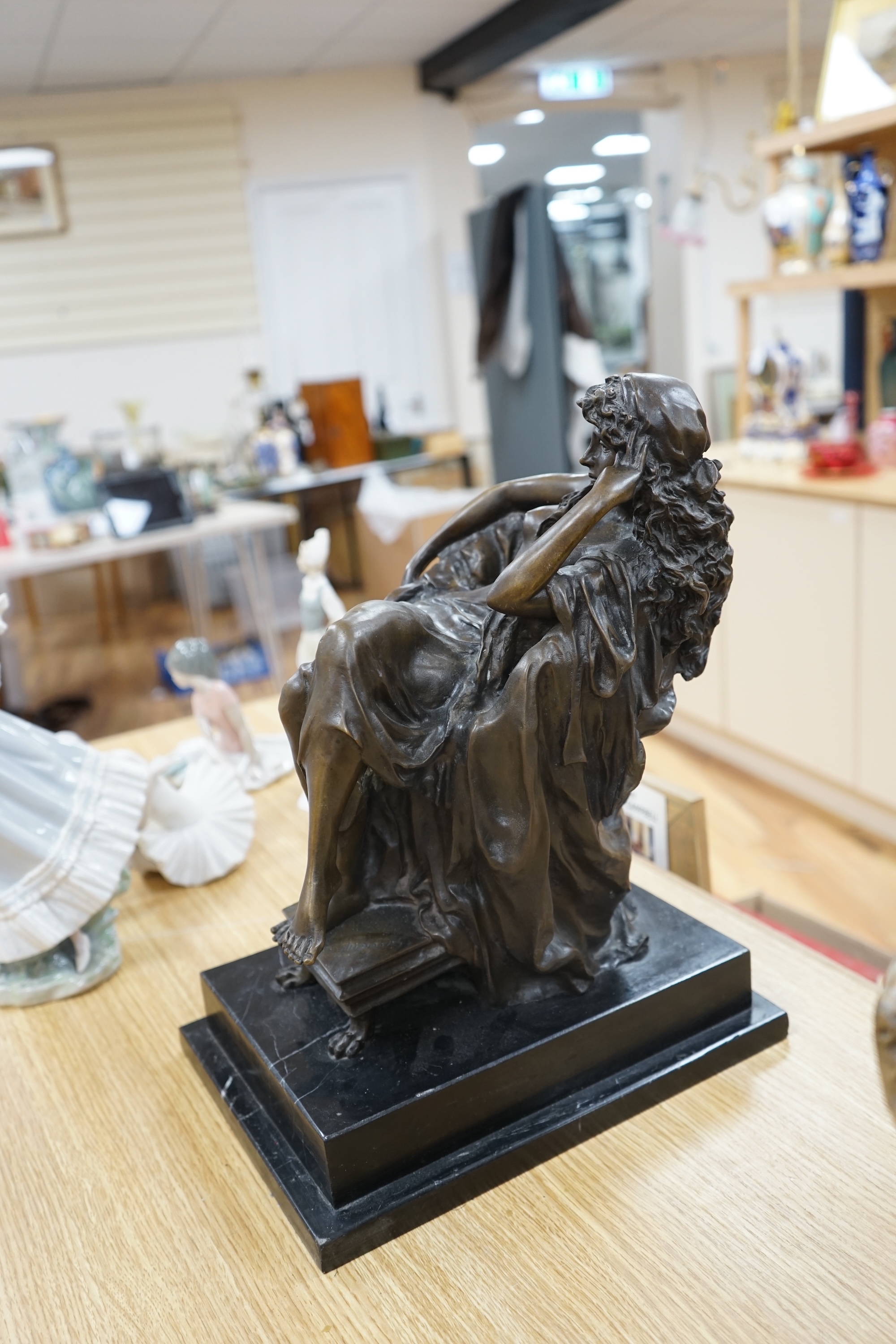 A decorative bronze study of a seated woman, raised on a stepped marble plinth, signed Chiparus, 41cm high. Condition - good